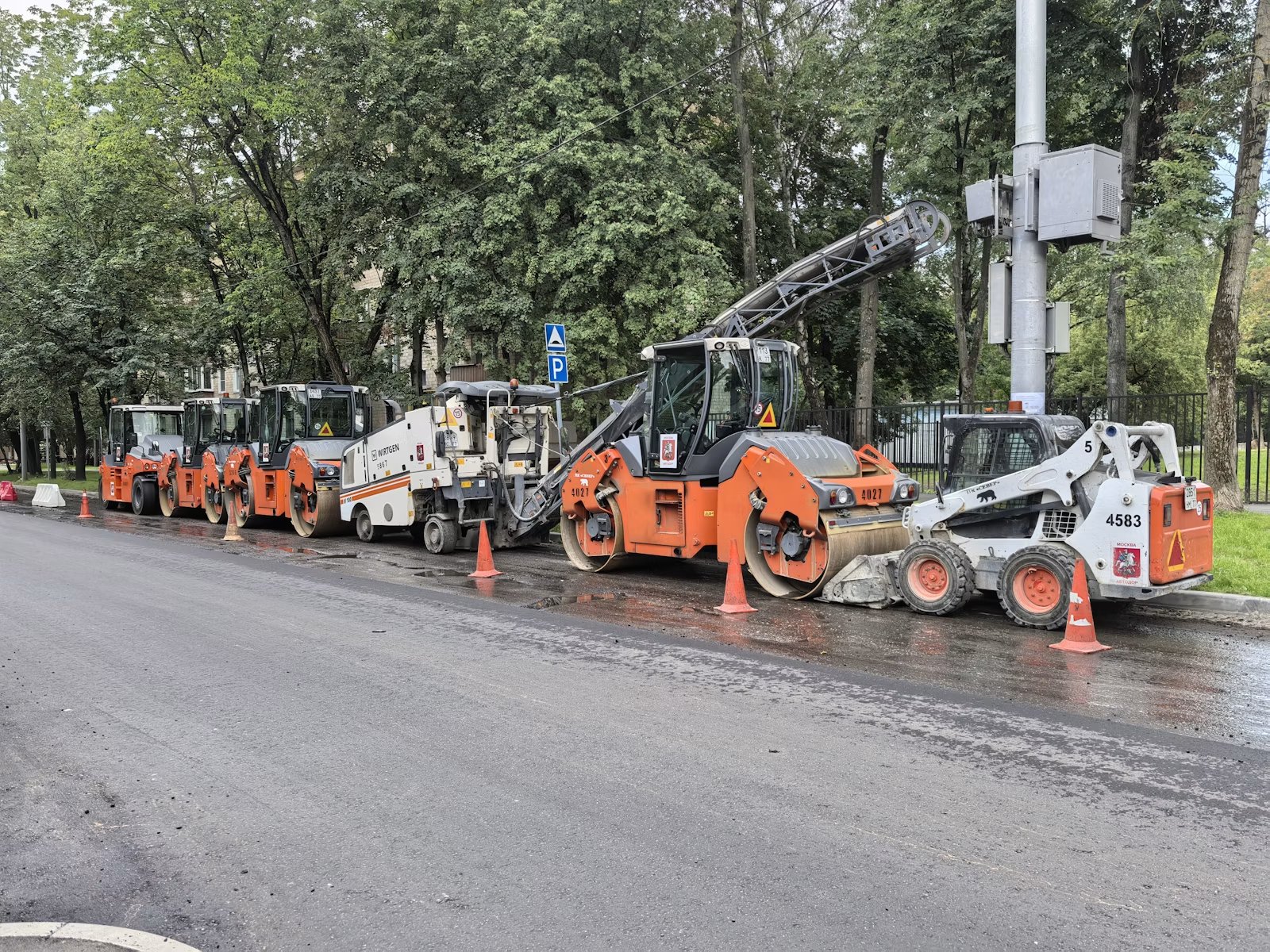 Road construction equipment on fresh asphalt